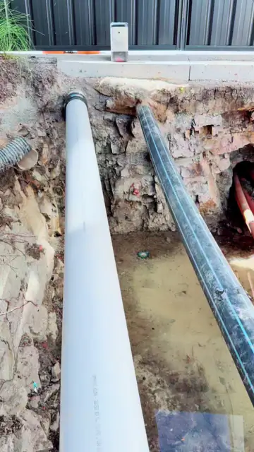 White conduit and drill pipe in an excavated pit in Canberra.