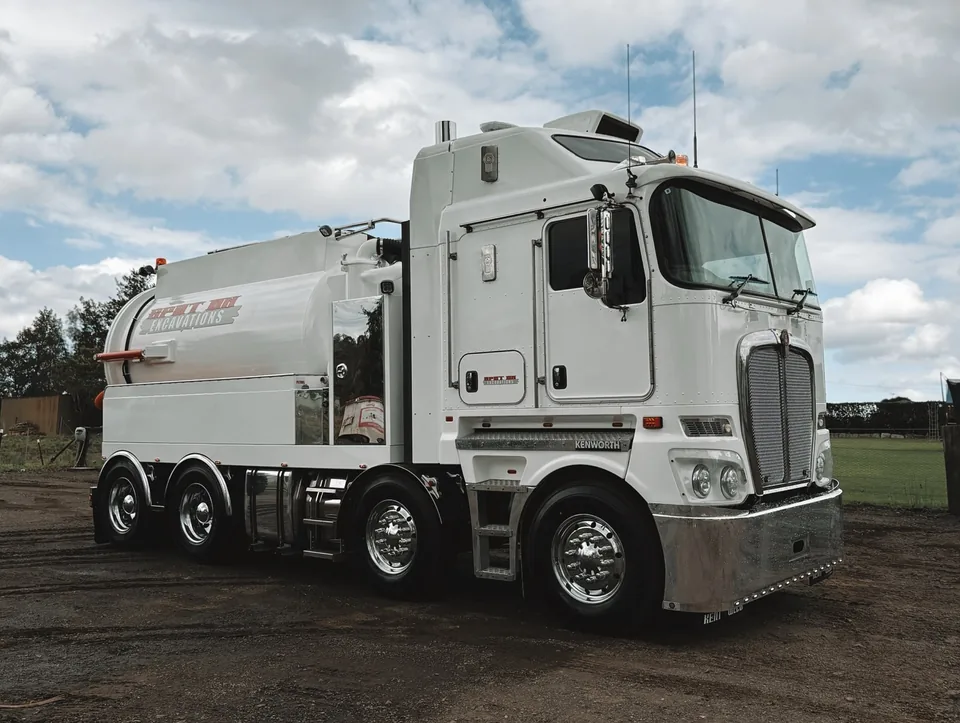 Spot On white hydrovac truck with its tank and hose equipment.