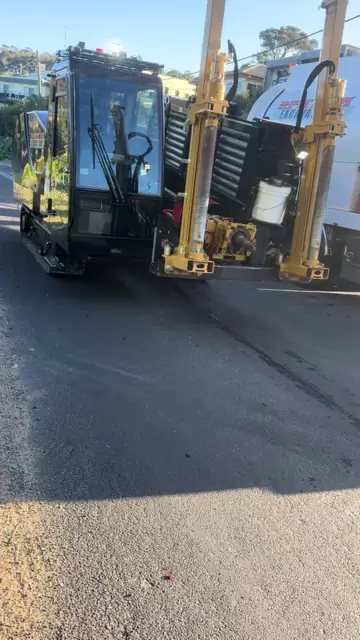 Vermeer drilling rig set up on a street for a rock shot.