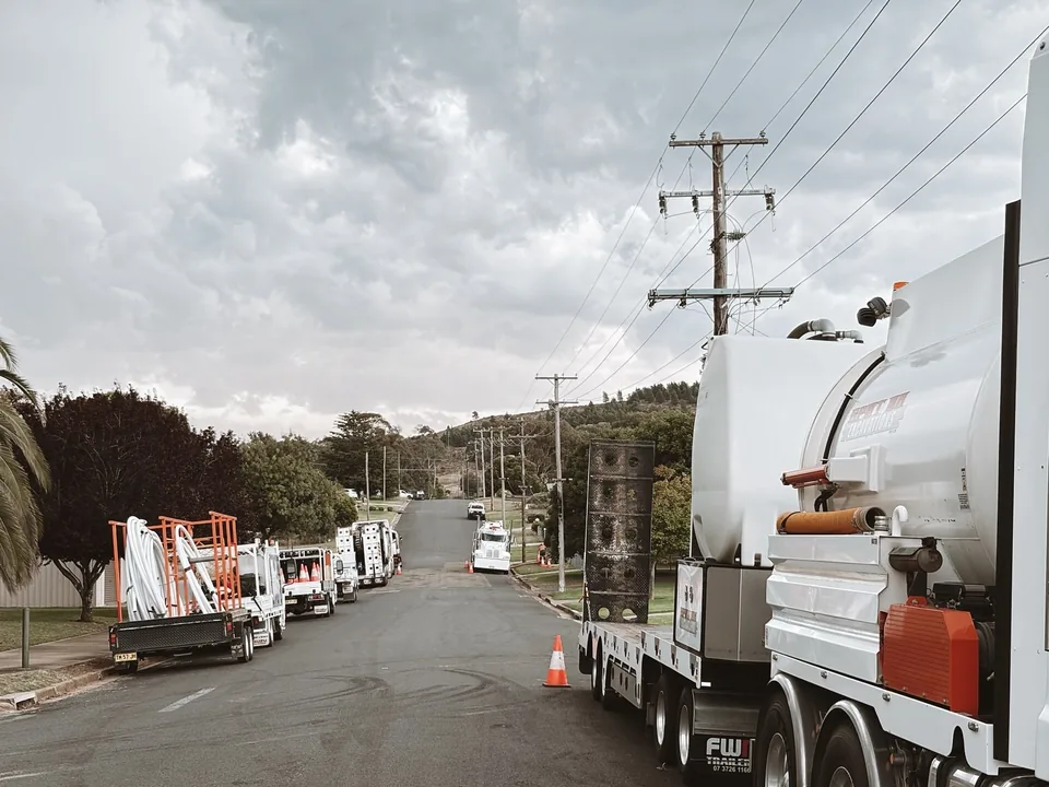 Spot On trucks and equipment positioned along a suburban street.