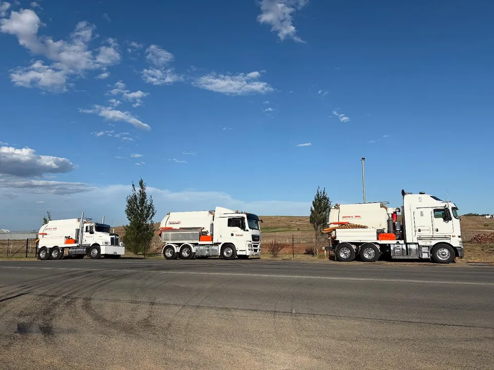 Three Spot On vacuum trucks lined up in the yard.